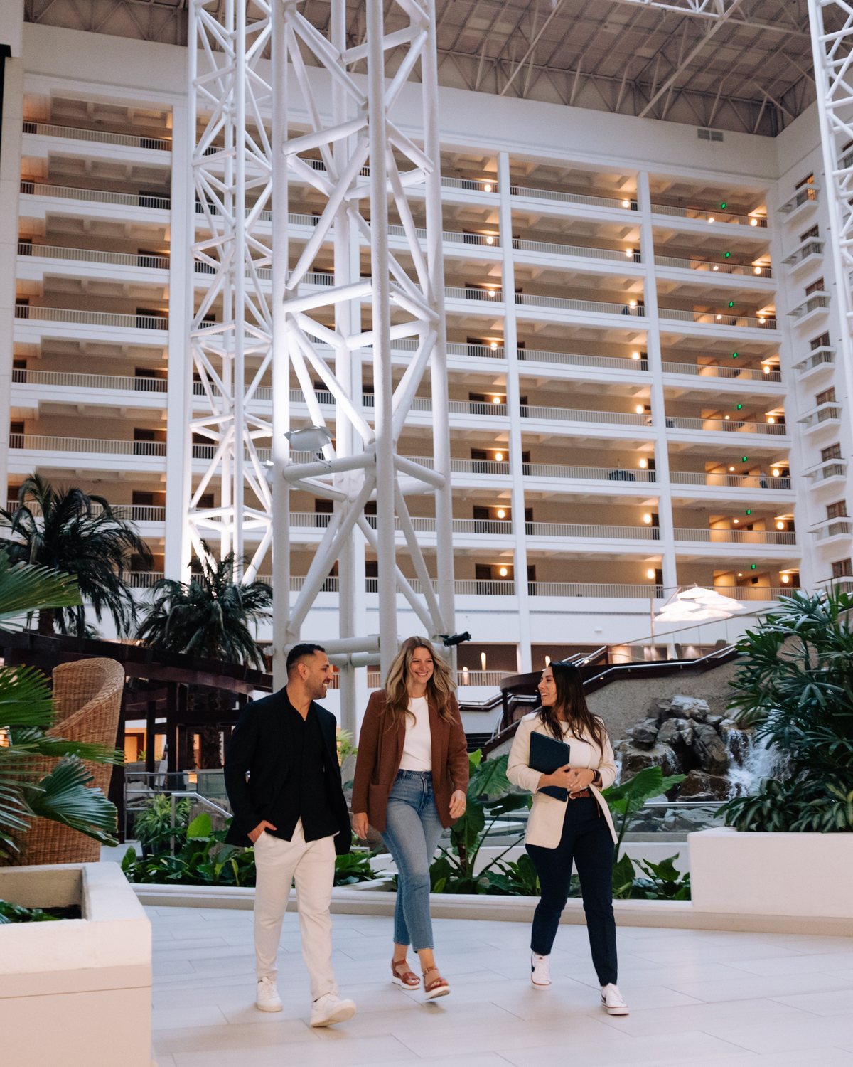 The EDM team walking through a hotel atrium on property
