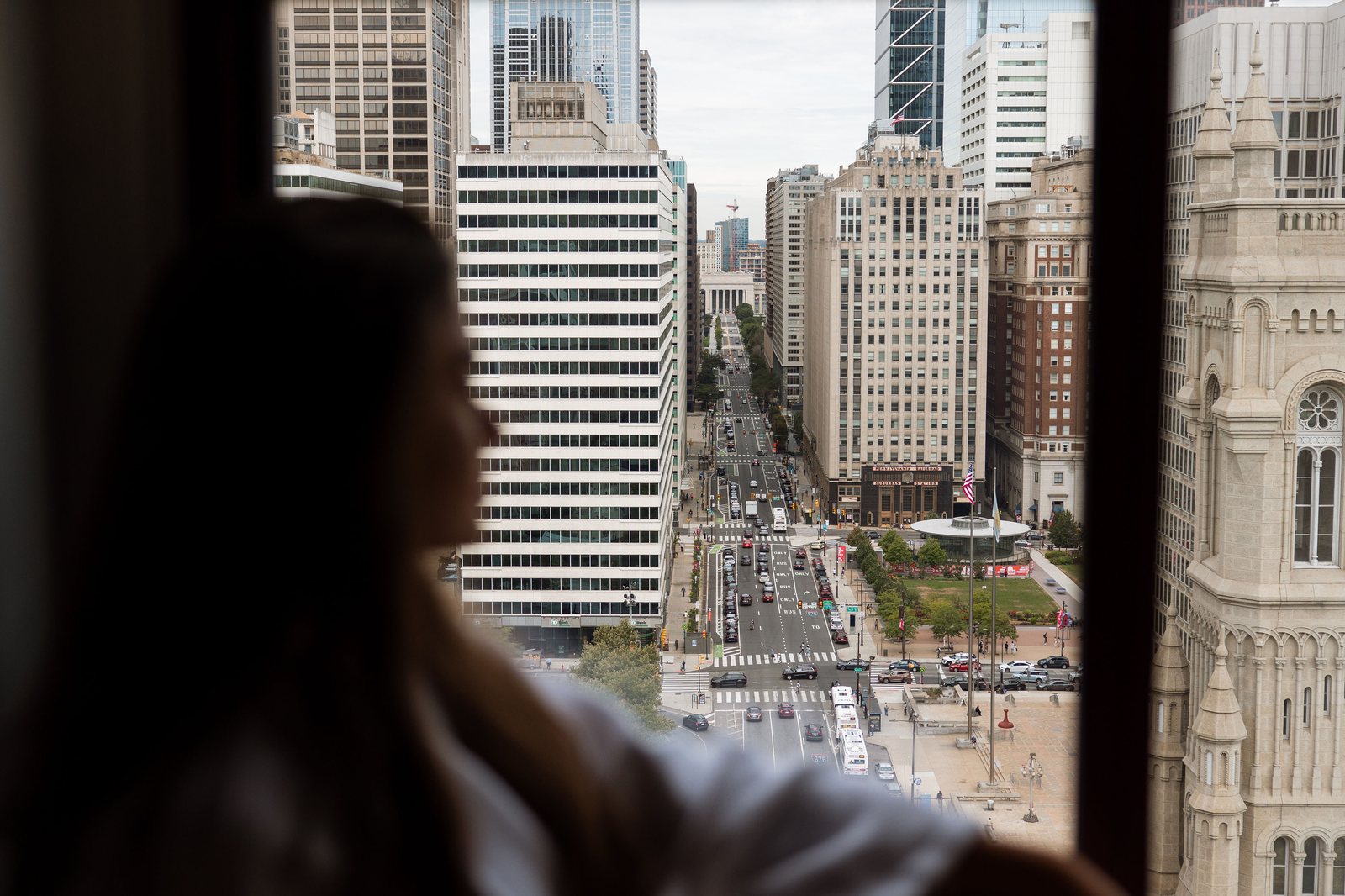 Guest looking out over Philadelphia from The Notary Hotel