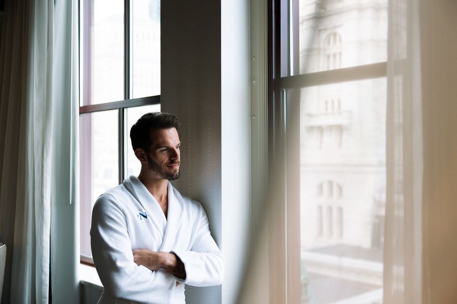 Guest in a robe by the window at The Notary Hotel