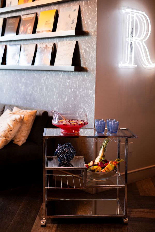 Punch bowl and fruit cart beneath the neon R in the lounge at Renaissance Los Angeles Airport Hotel